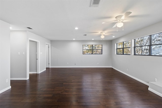 unfurnished room with ceiling fan and dark hardwood / wood-style flooring