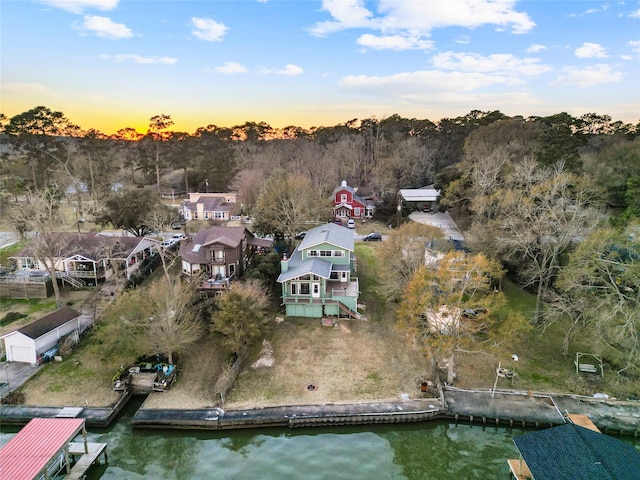 aerial view at dusk with a water view