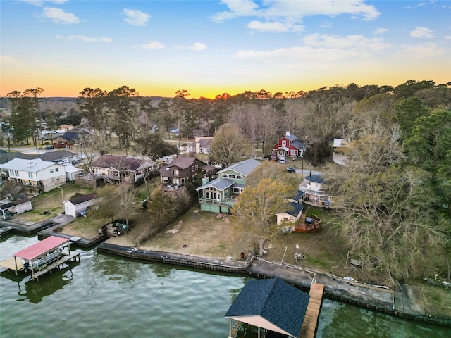 aerial view at dusk with a water view