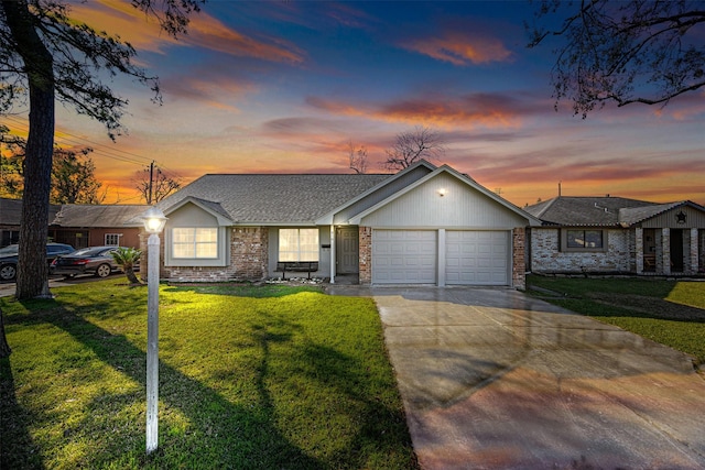 ranch-style house featuring a yard and a garage