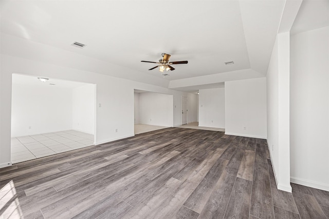 empty room featuring ceiling fan and hardwood / wood-style floors