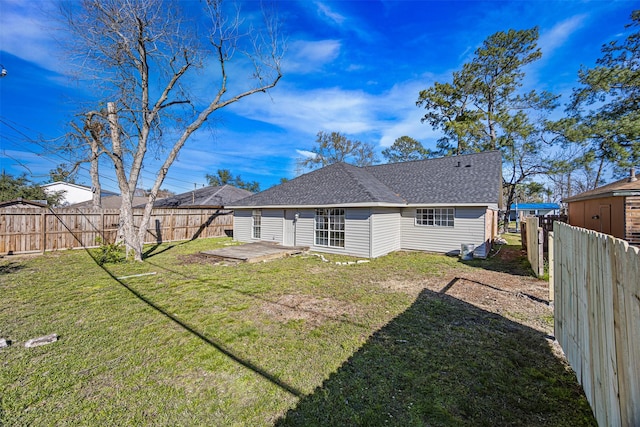 rear view of house with a patio and a yard