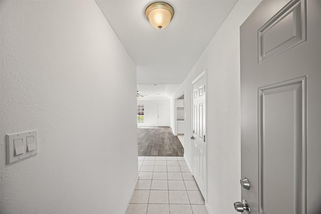 corridor featuring light tile patterned floors