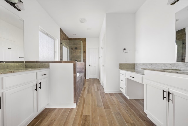 bathroom featuring vanity, wood-type flooring, and independent shower and bath