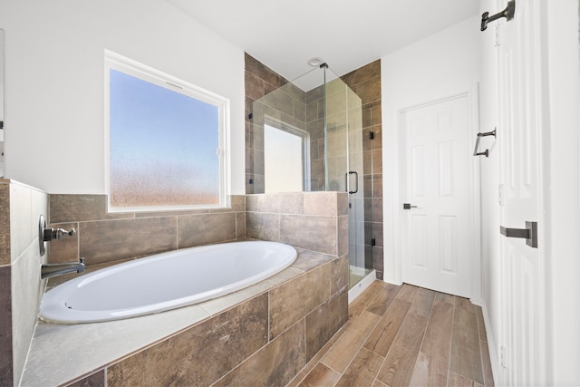 bathroom with wood-type flooring and plus walk in shower