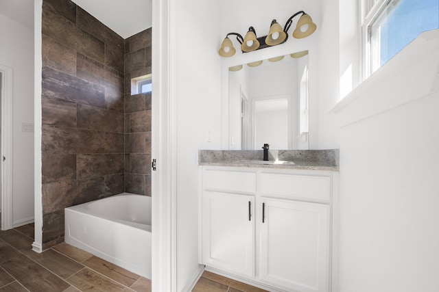 bathroom with vanity and tiled shower / bath combo