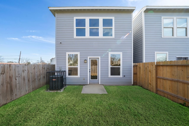 back of house featuring central AC and a lawn