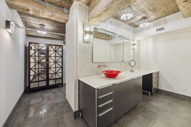 bathroom featuring tasteful backsplash and vanity