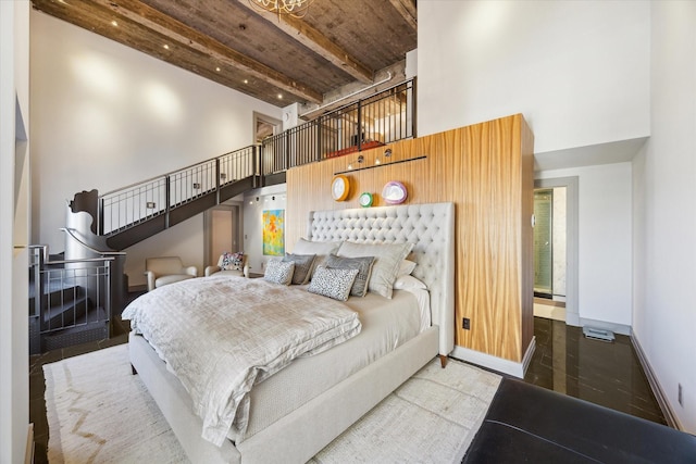 bedroom with hardwood / wood-style flooring and beam ceiling