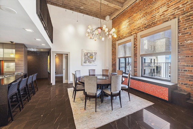 dining room featuring brick wall, beamed ceiling, a chandelier, a high ceiling, and wood ceiling