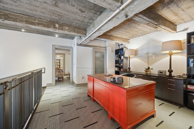 kitchen featuring beamed ceiling and a kitchen island