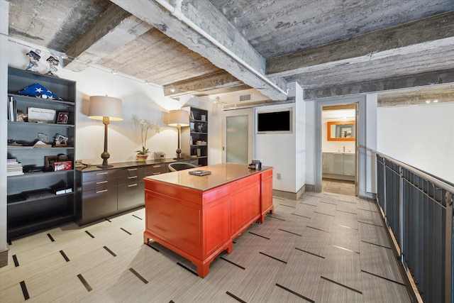 kitchen with beamed ceiling and a kitchen island