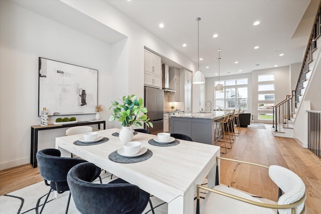 dining area featuring sink and light hardwood / wood-style flooring