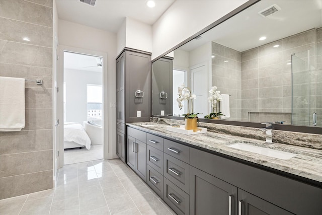 bathroom with vanity, tile patterned floors, and a shower with door