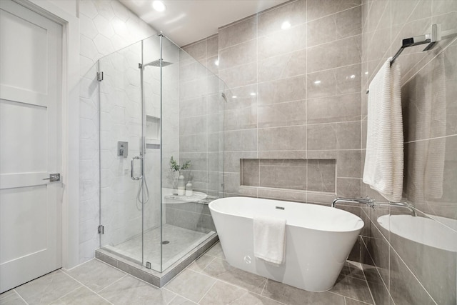 bathroom with tile walls and plus walk in shower