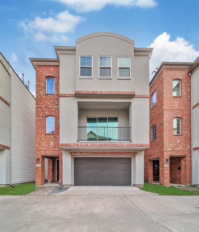 view of front of home featuring a garage and a balcony