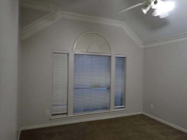 empty room with crown molding, ceiling fan, lofted ceiling, and dark colored carpet