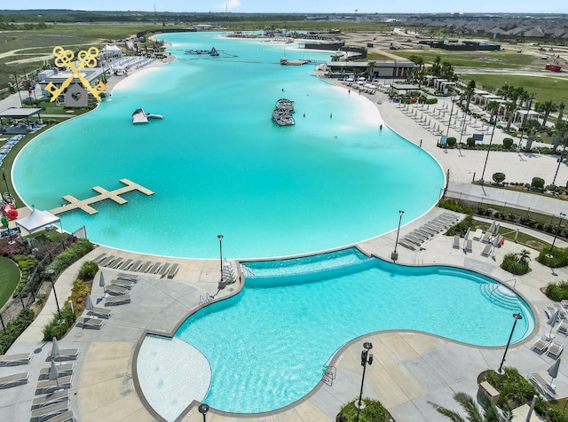 view of swimming pool with a water view