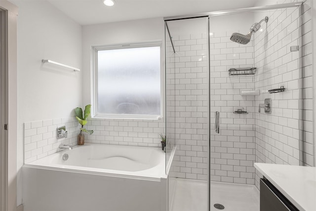 bathroom with vanity and independent shower and bath