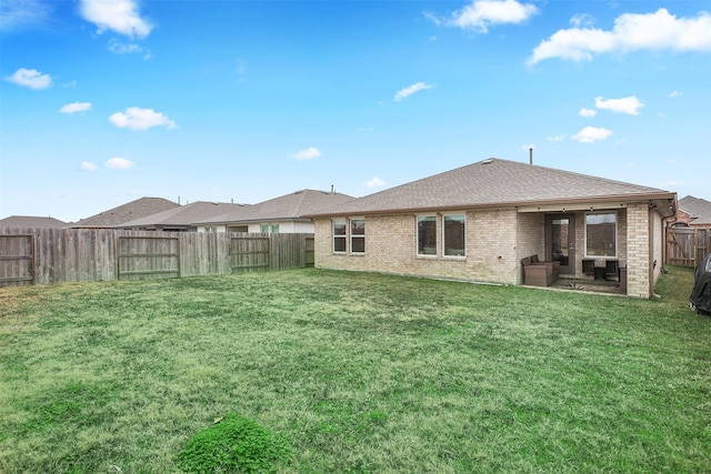 rear view of property with a lawn