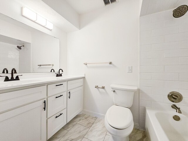 full bathroom featuring tiled shower / bath combo, vanity, and toilet