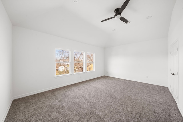 empty room with lofted ceiling, ceiling fan, and carpet