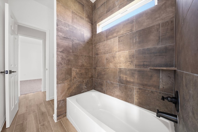 bathroom featuring bathing tub / shower combination and hardwood / wood-style floors