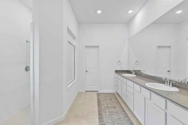 bathroom with vanity and tiled shower