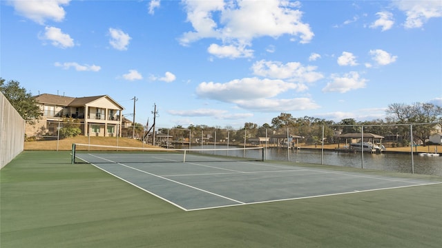 view of sport court with a water view