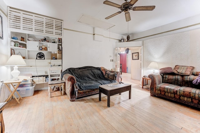 living room featuring ceiling fan and light hardwood / wood-style flooring