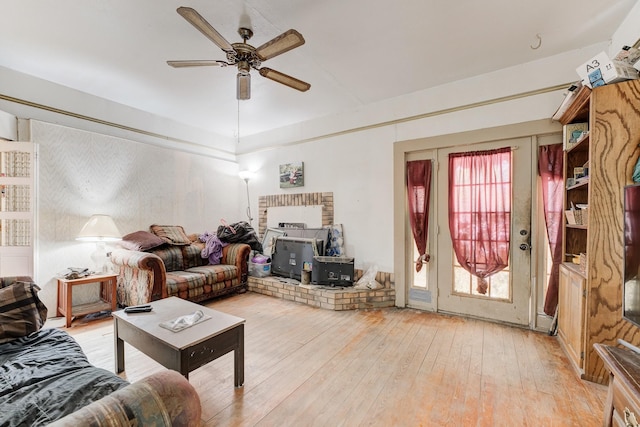 living room featuring ceiling fan, light hardwood / wood-style flooring, and a wealth of natural light