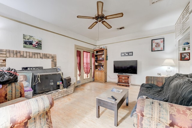 living room featuring ceiling fan and light wood-type flooring