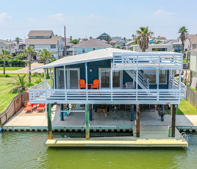 16513 Tampico Way, Jamaica Beach, TX 77554 - back of house featuring a deck with water view, stairway, and a residential view