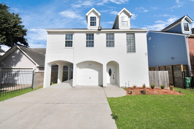 view of front of property with a garage and a front lawn