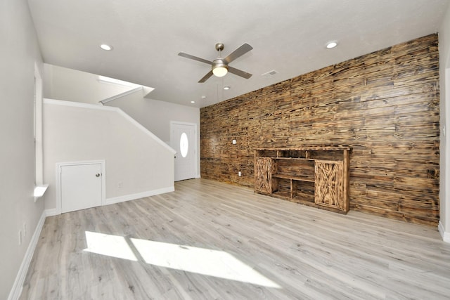 unfurnished living room featuring ceiling fan and light hardwood / wood-style flooring