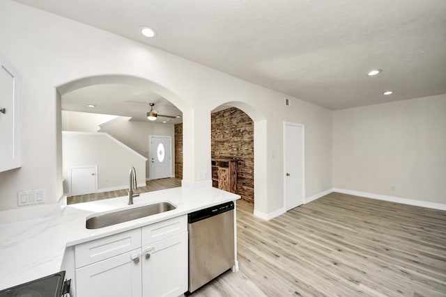 kitchen featuring white cabinetry, dishwasher, sink, and light hardwood / wood-style floors