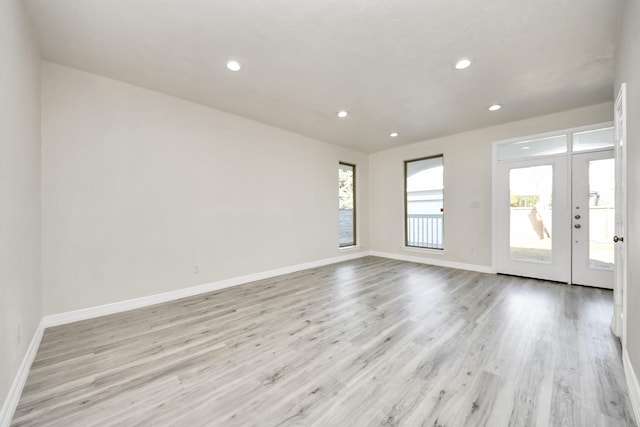 empty room with light hardwood / wood-style floors