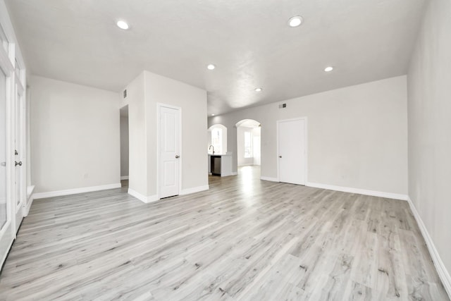 unfurnished living room featuring light wood-type flooring