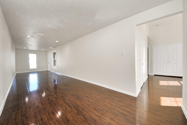 unfurnished room featuring dark wood-type flooring