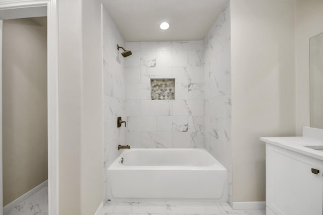 bathroom featuring vanity and tiled shower / bath