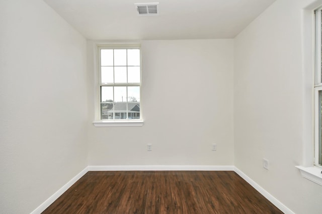 spare room with dark hardwood / wood-style floors