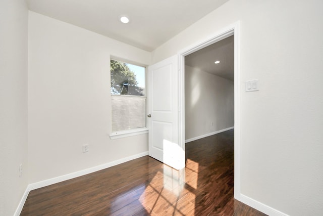 spare room featuring dark hardwood / wood-style flooring