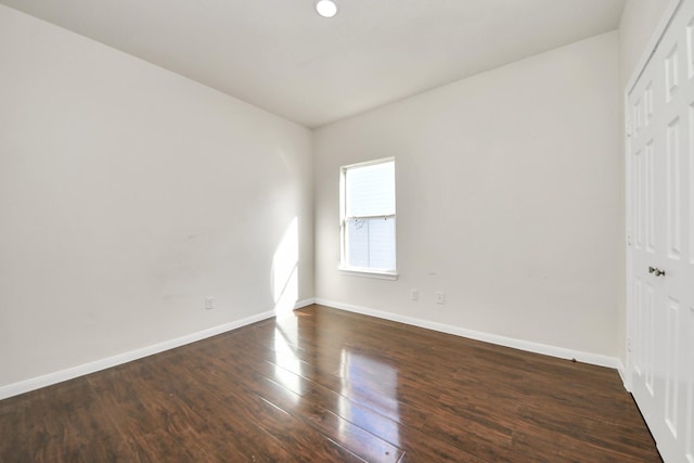 spare room with dark hardwood / wood-style flooring