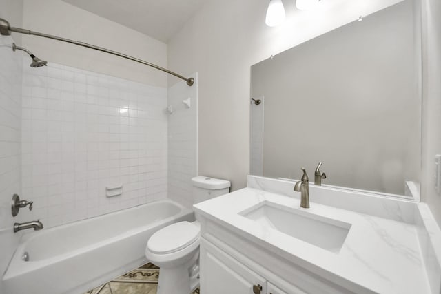 full bathroom with vanity, tiled shower / bath combo, and toilet