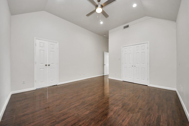 spare room with dark hardwood / wood-style flooring, high vaulted ceiling, and ceiling fan