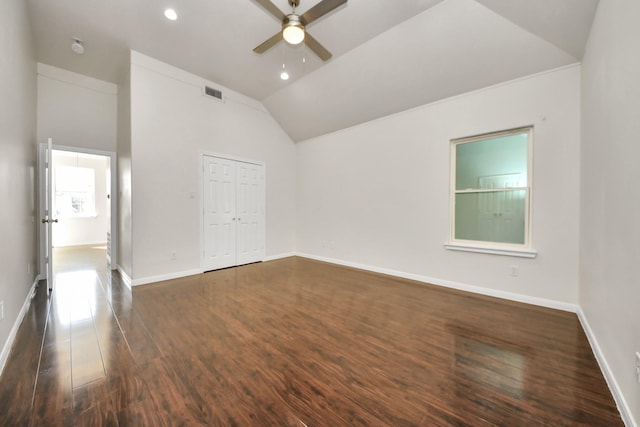 unfurnished room with ceiling fan, lofted ceiling, and dark hardwood / wood-style flooring