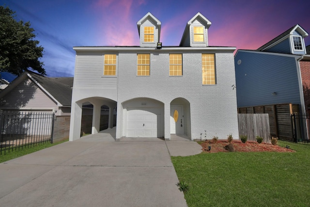 view of front of home with a garage and a yard