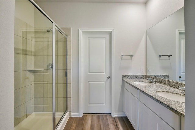 bathroom with vanity, an enclosed shower, and hardwood / wood-style floors