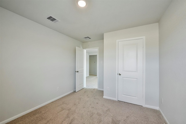 unfurnished bedroom featuring light carpet