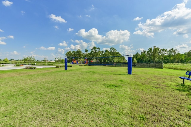 view of property's community featuring a lawn and volleyball court